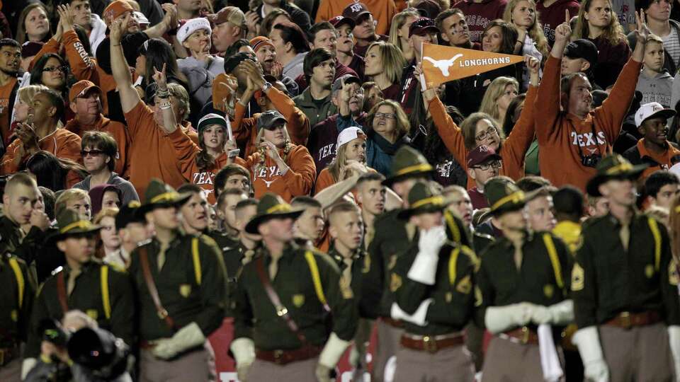 Texas fans, standing by Texas A&M Corps of Cadets members after Texas scored a touchdown during the third quarter of an NCAA college football game at Kyle Field Thursday, Nov. 24, 2011, in College Station. Texas beat Texas A&M 27-25. ( Brett Coomer / Houston Chronicle )