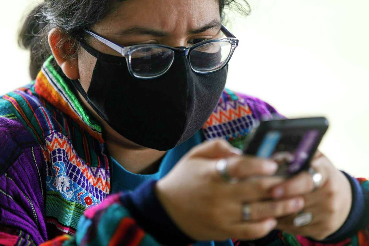 Emerald Alaniz, 17, explores the Project Youth Empowerment and Support modules on her phone at a Project Worth Teen Ambassador meet-up at Southside Lions Park last Saturday. Project YES, launched in April by UT Health San Antonio, offers mental health exercises teens can complete in about 30 minutes.