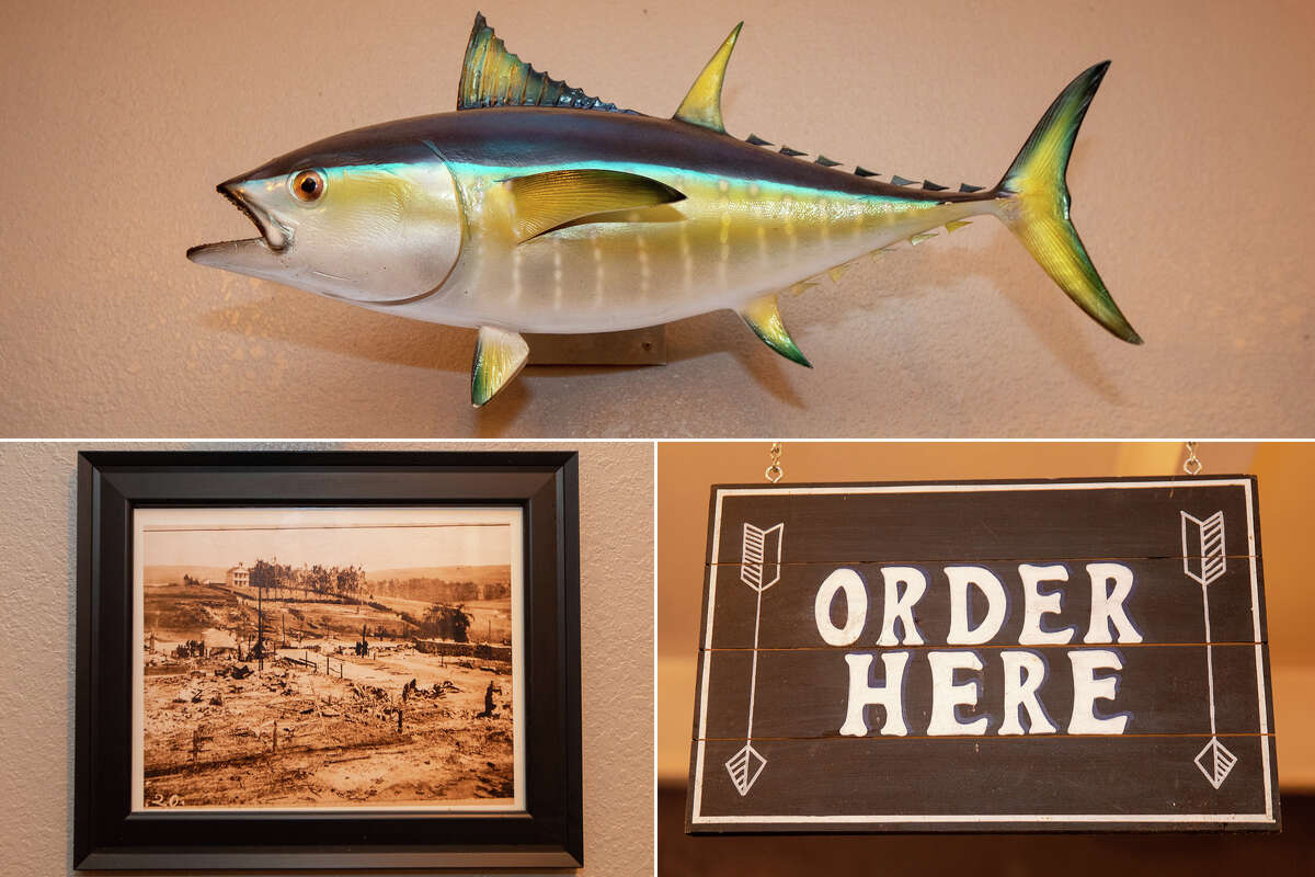Some of the interior decor, including historical photos of Tomales and a sign for where to order at the William Tell House in Tomales, Calif. on Nov. 18, 2021.
