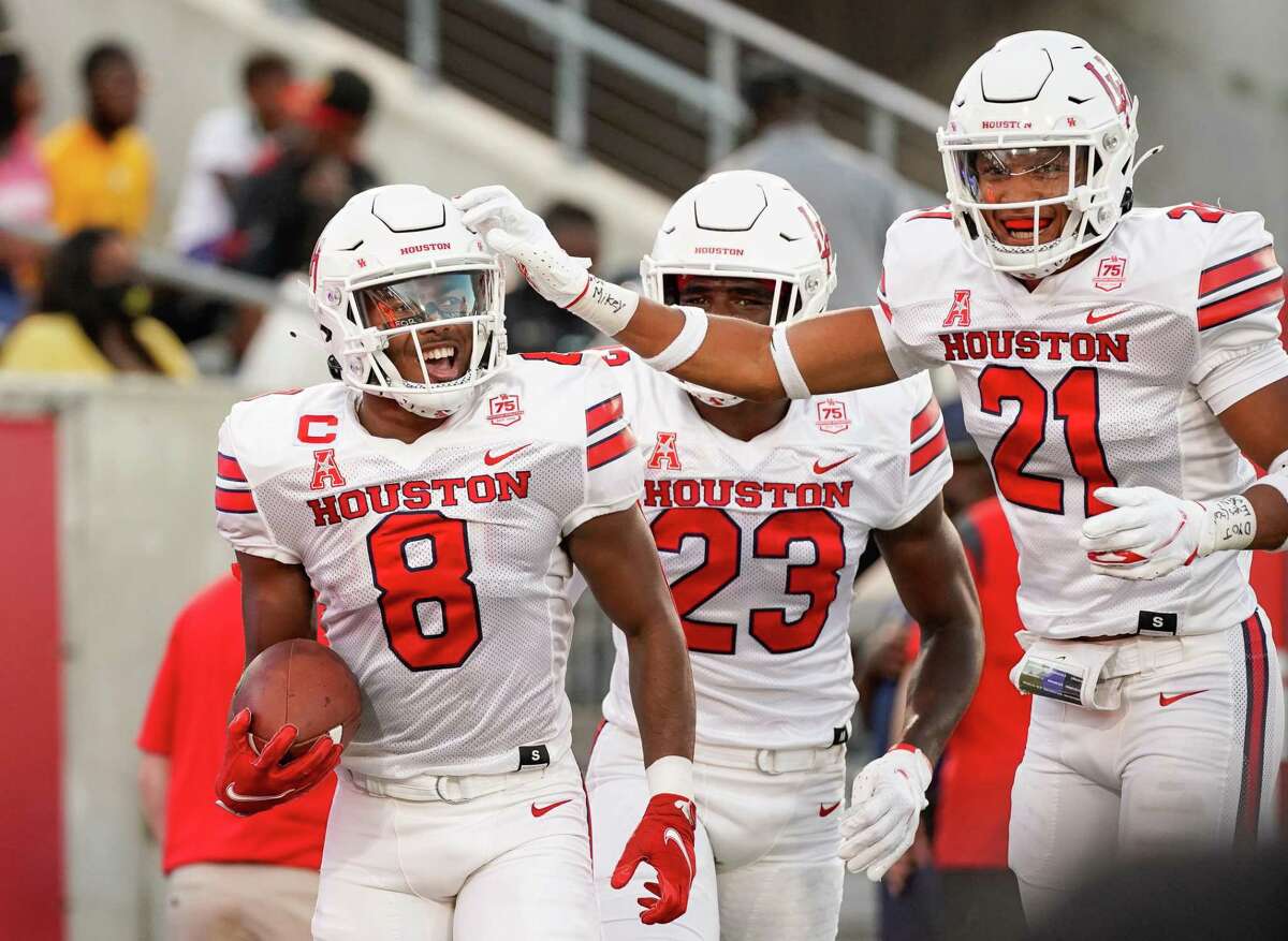 Houston Cougars cornerback Marcus Jones (8) celebrates with teammates after returning a punt for a 48-yard touchdown against the Grambling State Tigers during the second quarter of an NCAA game at TDECU Stadium on Saturday, Sept. 18, 2021, in Houston.