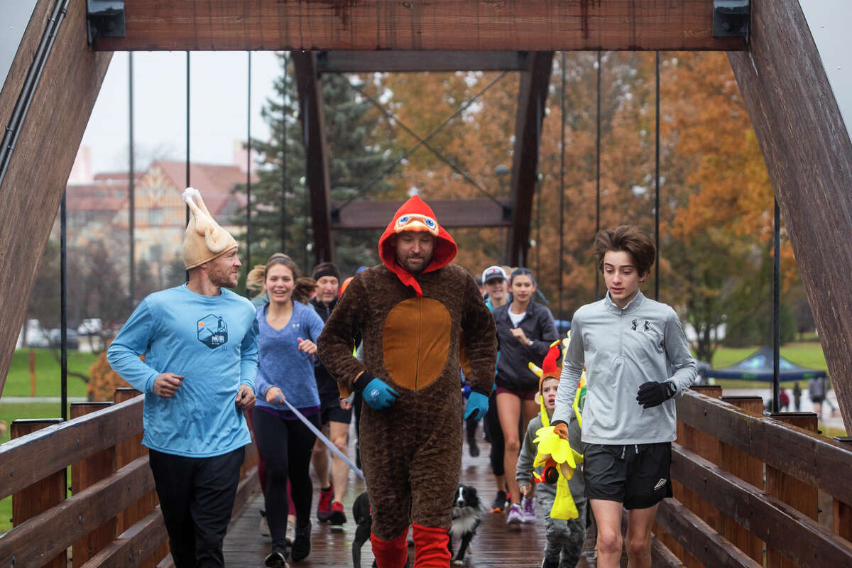Over 100 people gather for the annual Thanksgiving Day Turkey Trot Thursday, Nov. 25, 2021 at the Tridge in downtown Midland. (Katy Kildee/Midland Daily News)