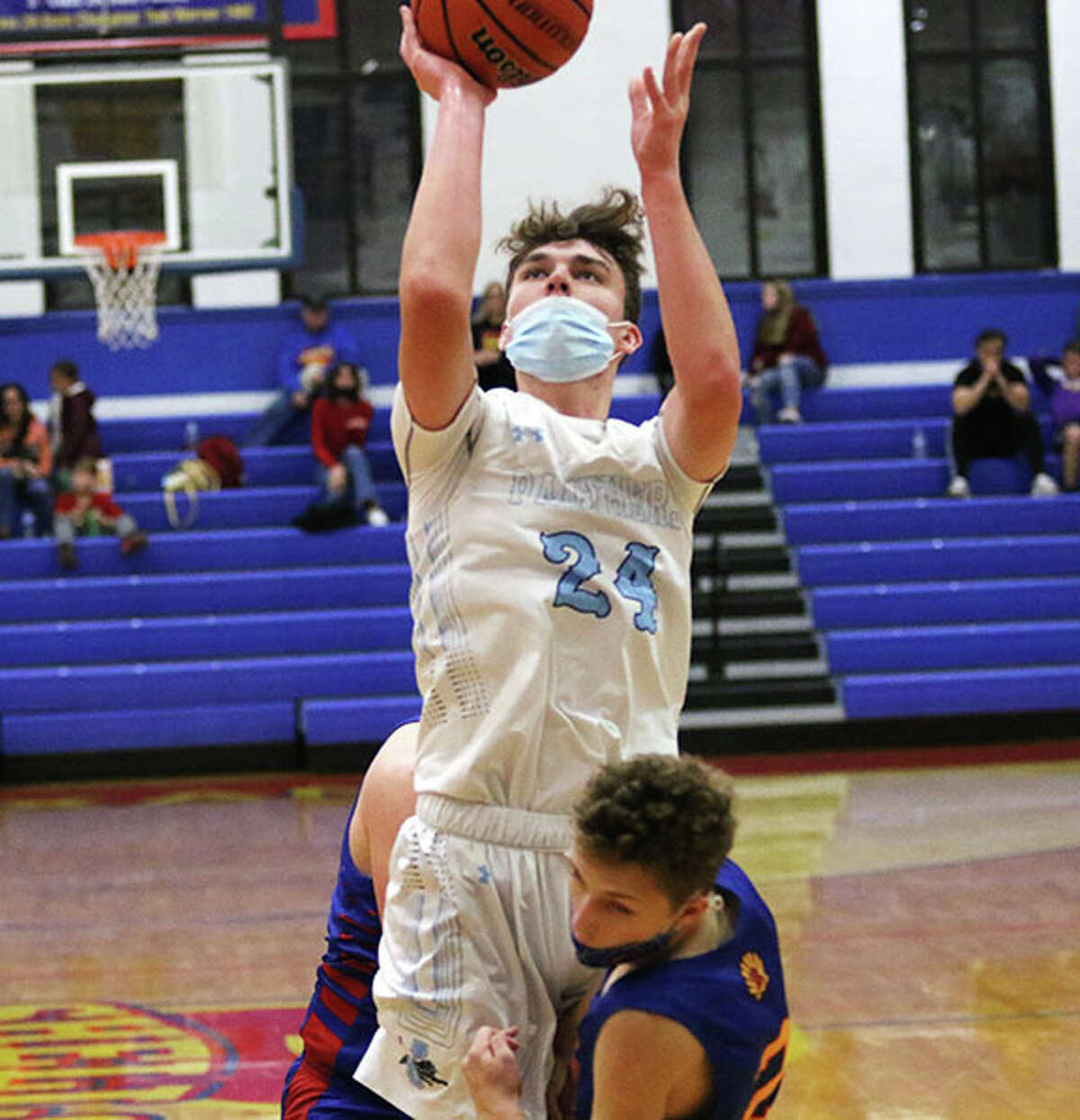 Jersey's Ayden Kanallakan (24) puts up a shot in the lane that is waved off with a charging call drawn by Roxana's Nolan Tolbert in a Monday game at the Roxana Tourney. On Wednesday, Kanallakan 13 points in another Jersey win in the tournament.