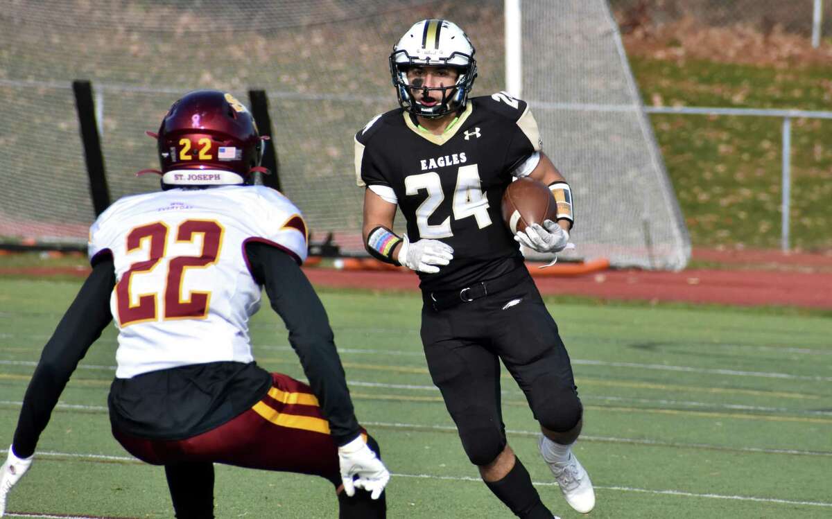 Trumbull's Nicholas Tuccinardi runs the ball during the Rumble in Trumbull rivalry football game between Trumbull and St. Joseph at McDougall Stadium Trumbull on Thursday, Nov. 25, 2021.