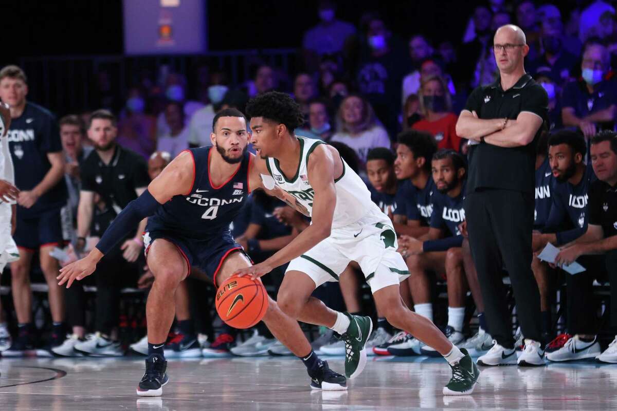 Michigan State Spartans guard Jaden Akins (3) and UConn guard Tyrese Martin (4) at the Battle 4 Atlantis Thursday, November 25, 2021 at Atlantis, Paradise Island in the Bahamas.