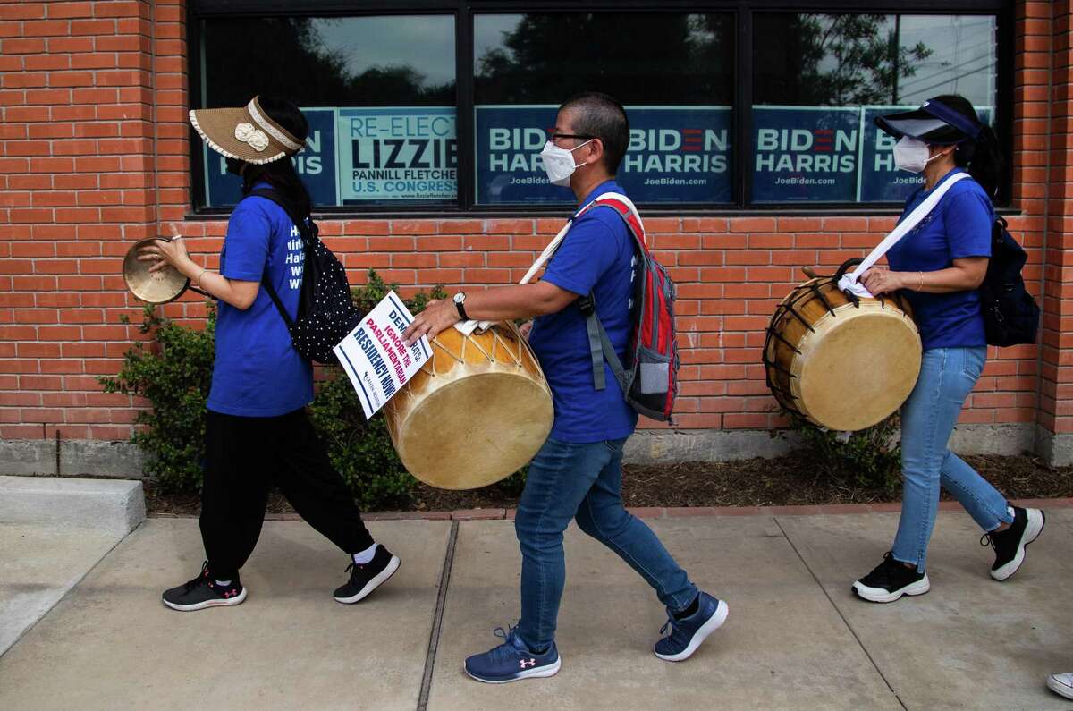 Woori Juntos’ Hyunsuk Heo, left, Hyunja Norman, center, and Sihwa Gi, participate in a protest in front of the Harris County Democratic Party offices, Wednesday, Oct. 20, 2021, in Houston.
