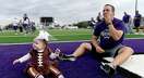 Port Neches - Groves assistant coach Mathew Newton has a breakfast donut in the end zone while daughter Caroline, dressed as a football, plays nearby while joining the traditional gathering after football practice Thanksgiving morning. Player and coaches' families lined the sideline, taking in the practice while enjoyinng a Thanksgiving breakfast of donuts and coffee. After, they stayed to spend time with their football family before breaking off to enjoy the holiday with relatives and friends.
Photo made Thursday, November 25, 2021
Kim Brent/The Enterprise
