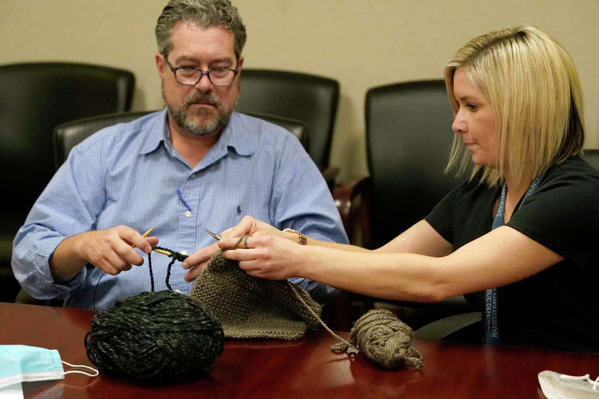 Stephen Touchstone and Kim Cleary, both assistant public defenders, participate in the Harris County Public Defenders’ Office knitting club Tuesday, Nov. 16, 2021 in Houston.