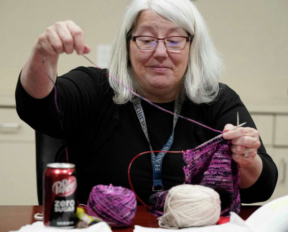 Jani Maselli, chief of appellate division, right, who founded the Harris County Public Defenders’ Office knitting club, knits during a club meeting Tuesday, Nov. 16, 2021 in Houston.