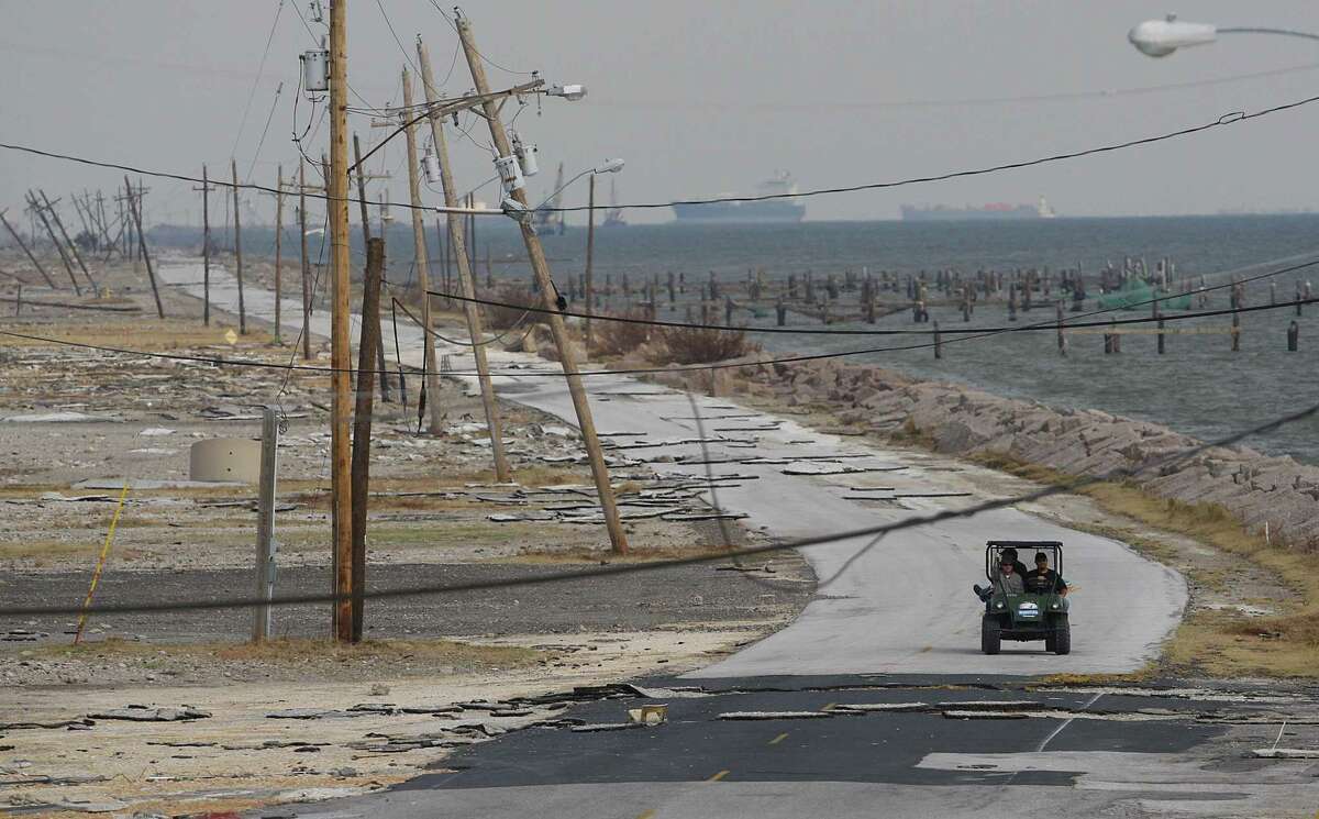 A worker crew drives out of the Texas City Dike where all the businesses were gone and the road damaged by Hurricane Ike on Wednesday, September 24, 2008 in Texas City.