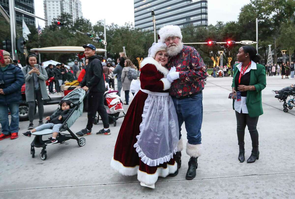 Mr. and Mrs. Claus pose for a photo as they greeted people during the 33rd Annual Uptown Holiday Lighting, Thursday, Nov. 25, 2021 in Houston. The evening will culminate with a dazzling tree light show and fireworks extravaganza, illuminating Houston from the sidewalks to the sky.