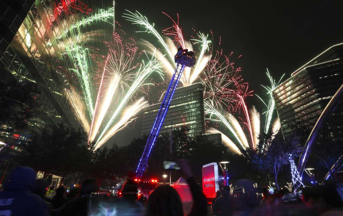 Santa on a Houston ladder truck as the fireworks lit up the sky during the 33rd Annual Uptown Holiday Lighting, Thursday, Nov. 25, 2021 in Houston. The evening will culminate with a dazzling tree light show and fireworks extravaganza, illuminating Houston from the sidewalks to the sky.