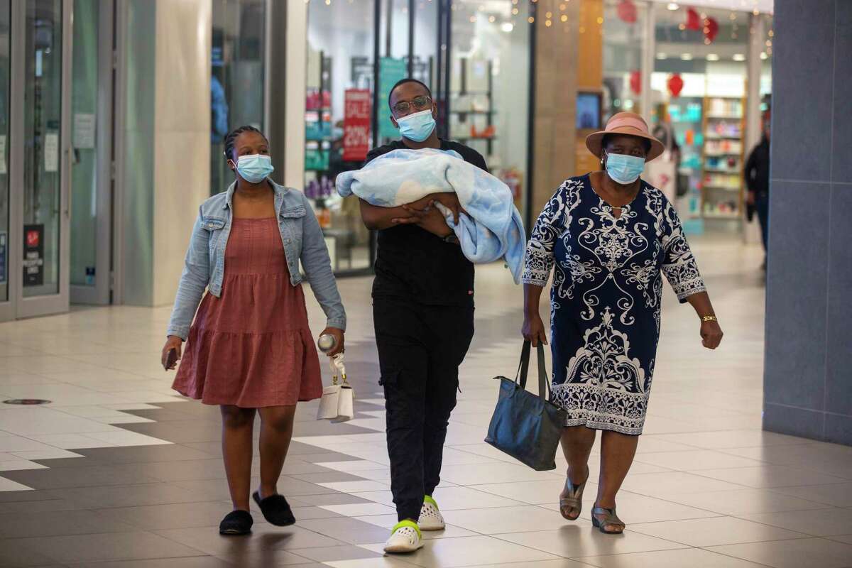 People with masks walik, at a shopping mall, in Johannesburg, South Africa, Friday Nov. 26, 2021. Advisers to the World Health Organization are holding a special session Friday to flesh out information about a worrying new variant of the coronavirus that has emerged in South Africa, though its impact on COVID-19 vaccines may not be known for weeks.