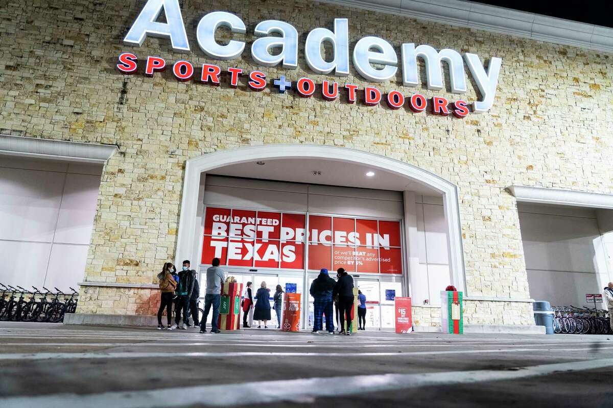 People wait outside of the Academy on the Katy Freeway near Gessner Road for the doors to open at 5am for Black Friday, Nov. 26, 2021, in Houston.