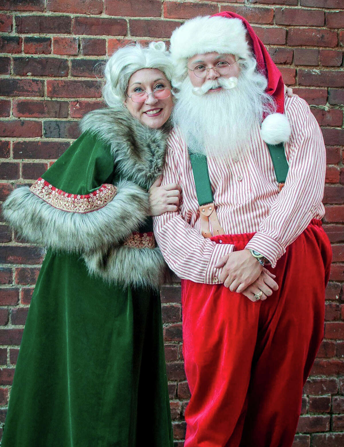 At age 21, Hunter Woodson, right, with Ashley Carter as Mrs. Claus, is pretty young to play Old St. Nick, but he's able to pull it off.