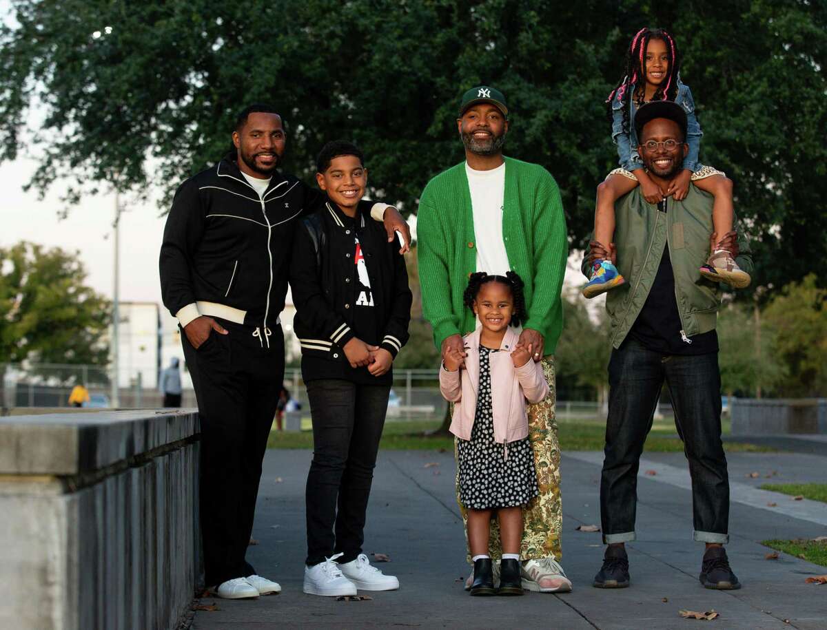 Gavin Adams, left to right, with his son Gavin Gian, Kevin Barnett with his daughter Knox Jean, and Devon Fanfair with his daughter Sage, gathered at Emancipation Park to talk about fatherhood. The men are part of CoolxDad, a group of local fathers of color who have united during the pandemic to make the world better for their children and their community, that was founded by Barnett. 