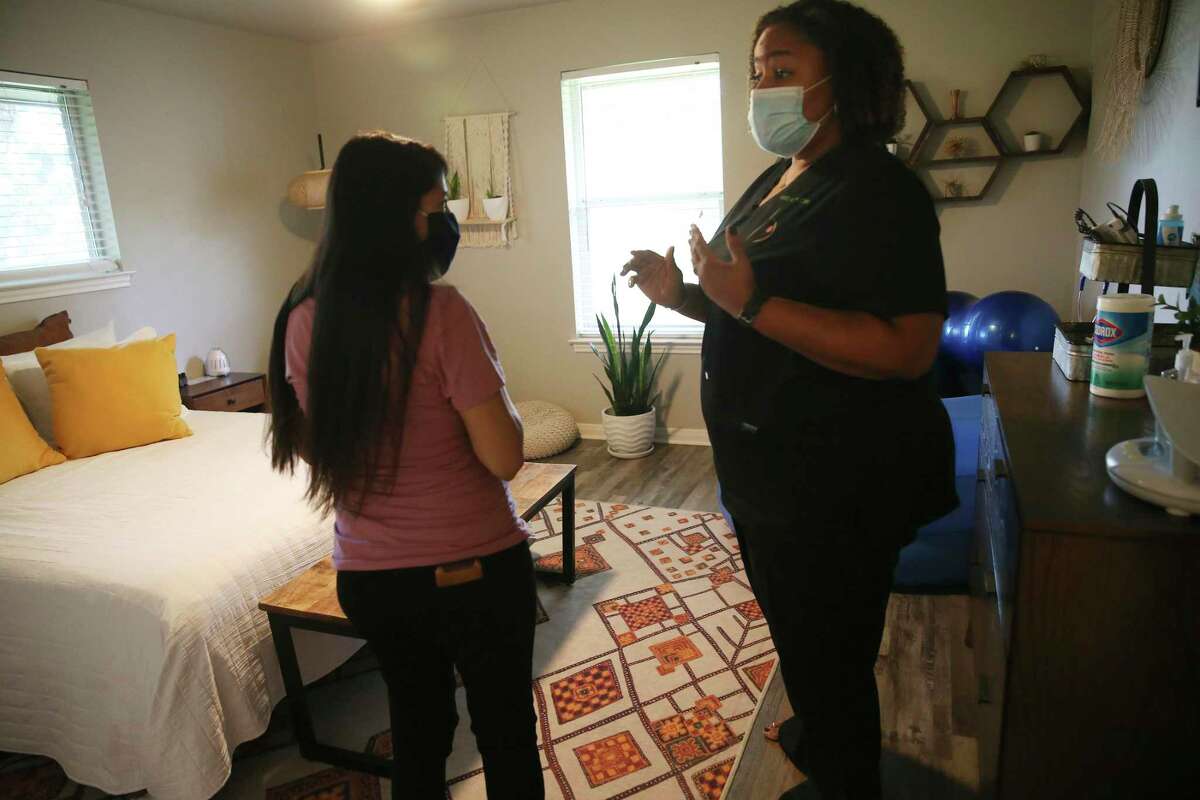 Nikki McIver-Brown speaks with her patient, Ana Gabriela Flores, before an exam. In mid-October, Flores was about 31 weeks pregnant.