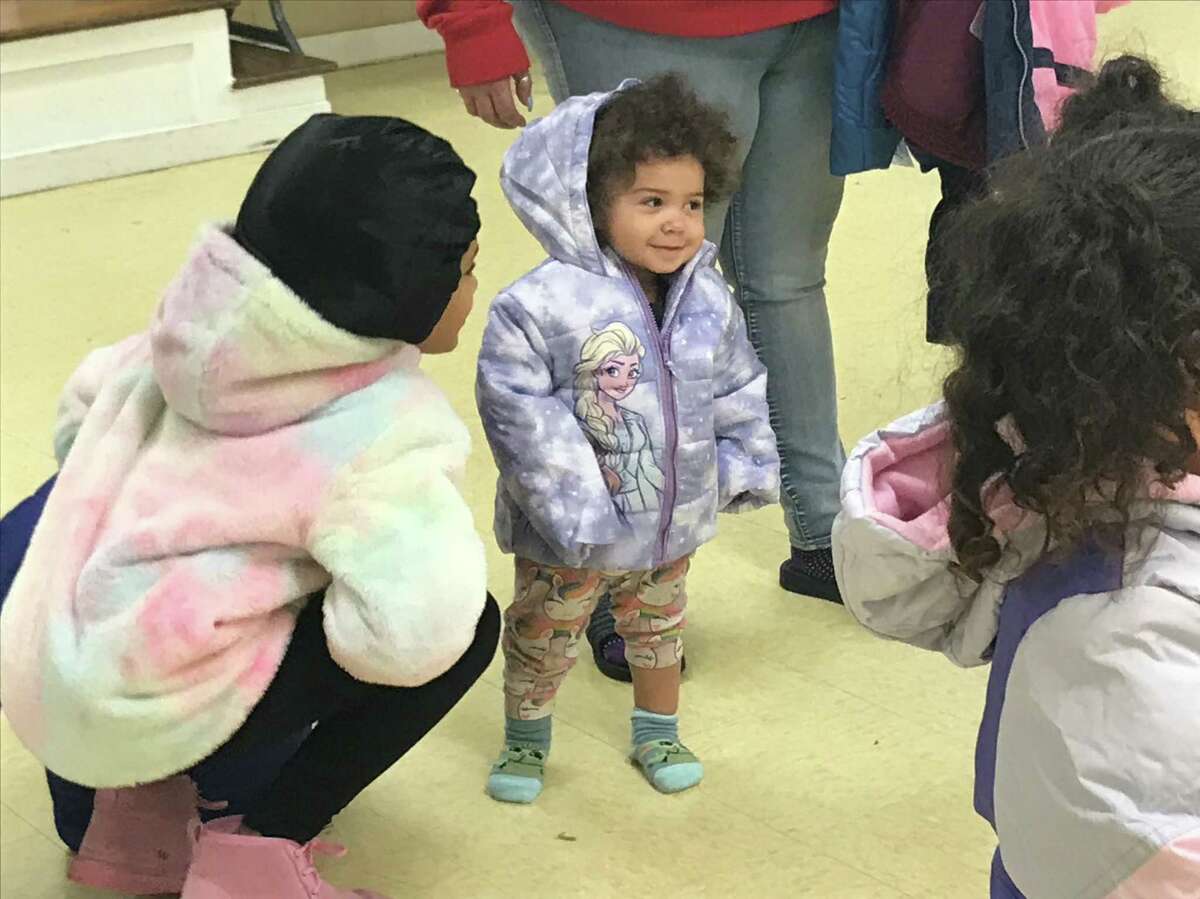 Amaya Cousins, 1, tries on a new winter coat on Nov. 26, 2021.