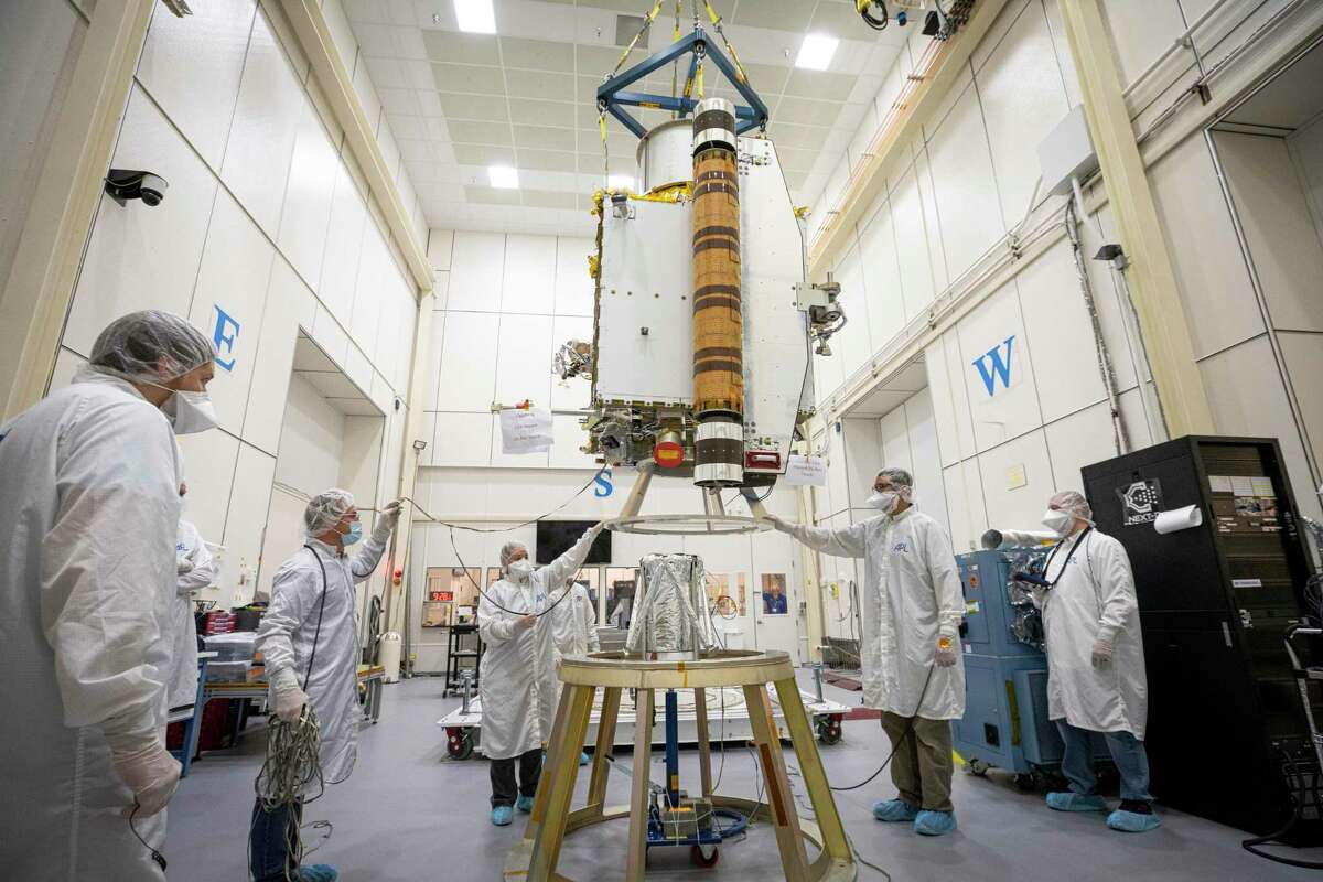 A photo provided by NASA shows members of the DART team installing the Double Asteroid Redirection Test spacecraft's only instrument, the Didymos Reconnaissance and Asteroid Camera for Optical navigation (DRACO), in June 2021. The DART spacecraft could be the first to alter an asteroid? s path, a technique that can be used to defend the planet in the future. (NASA via The New York Times)? ' FOR EDITORIAL USE ONLY? '