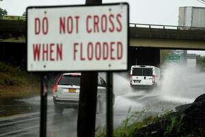 Vehicles cross a flooded viaduct during a storm last month in Stratford.
