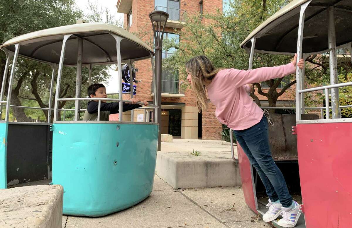 Mark Rodriguez, 8, and sister Allison Rodriguez, 11, from Missouri City play inside a couple of restored sky ride gondolas at Hemisfair earlier this month. The gondolas are from the original Brackenridge Park sky ride, which ran from 1964 to 1999.