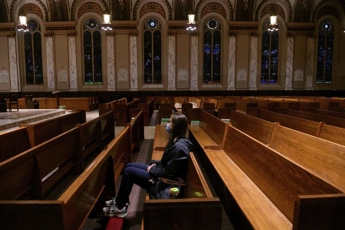 A woman arrives early for the Mass at St. Joseph Church in New Haven Nov. 12, 2021.
