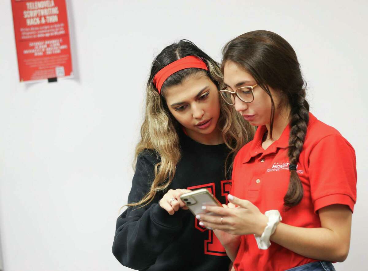 University of Houston seniors Michelle Abrams, left, and Mariana Cordero go over their notes before a presentation with classmate Dylan Esquina on their project producing telenovelas as a way to raise mental health awareness in the the Latino community on Thursday, Nov. 18, 2021. The project is led by University of Houston professor Luis D. Medina, who founded the Engaging Communities of Hispanics for Aging Research Network with a $2.35 million grant from the National Institute on Aging.