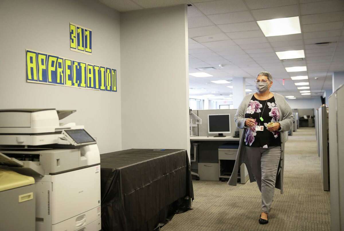 Vera Abrego, a supervisor, walks to her office in the city’s 311 call center in Houston.