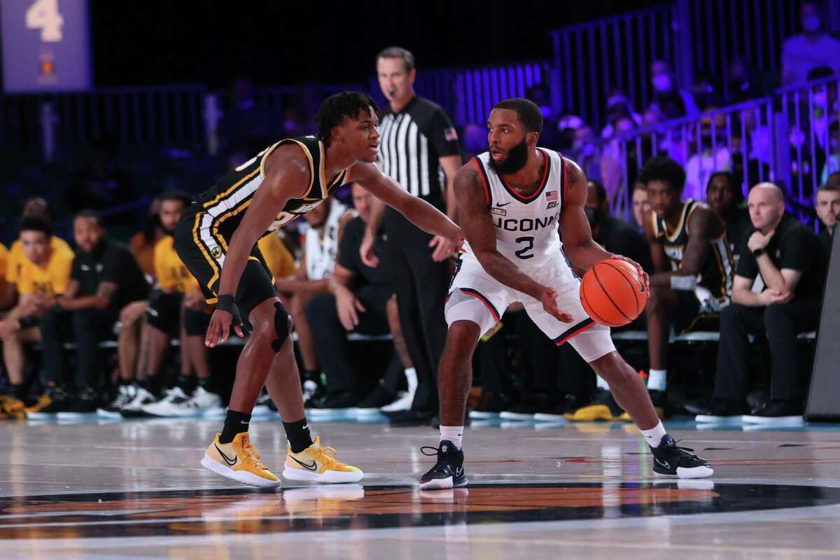 UConn’s R.J. Cole (2) handles the ball in front of a VCU defender at the Bad Boy Mower’s Battle 4 Atlantis on Friday.
