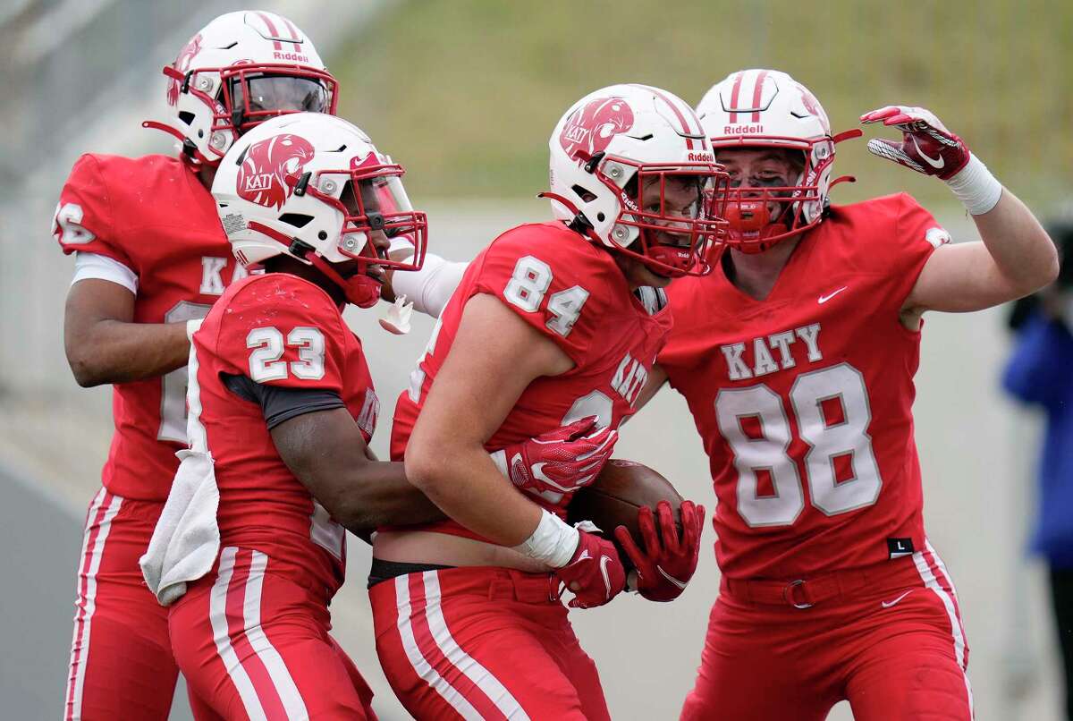 Katy tight end Luke Carter (84) celebrates his touchdown with Isaiah Smith, left, Seth Davis (23), and Michael Dante (88) during the second half of a 6A Division II regional semi-final high school football playoff game against C.E. King, Friday, Nov. 26, 2021, in Katy.