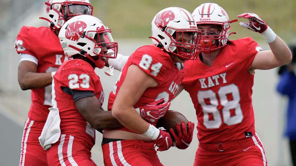 Katy tight end Luke Carter (84) celebrates his touchdown with Isaiah Smith, left, Seth Davis (23), and Michael Dante (88) during the second half of a 6A Division II regional semi-final high school football playoff game against C.E. King, Friday, Nov. 26, 2021, in Katy.