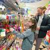 Johan Lang, of Greenwich, and his daughter Ellie, 8, shop for holiday toys at Funky Monkey toy store in Greenwich on Friday.