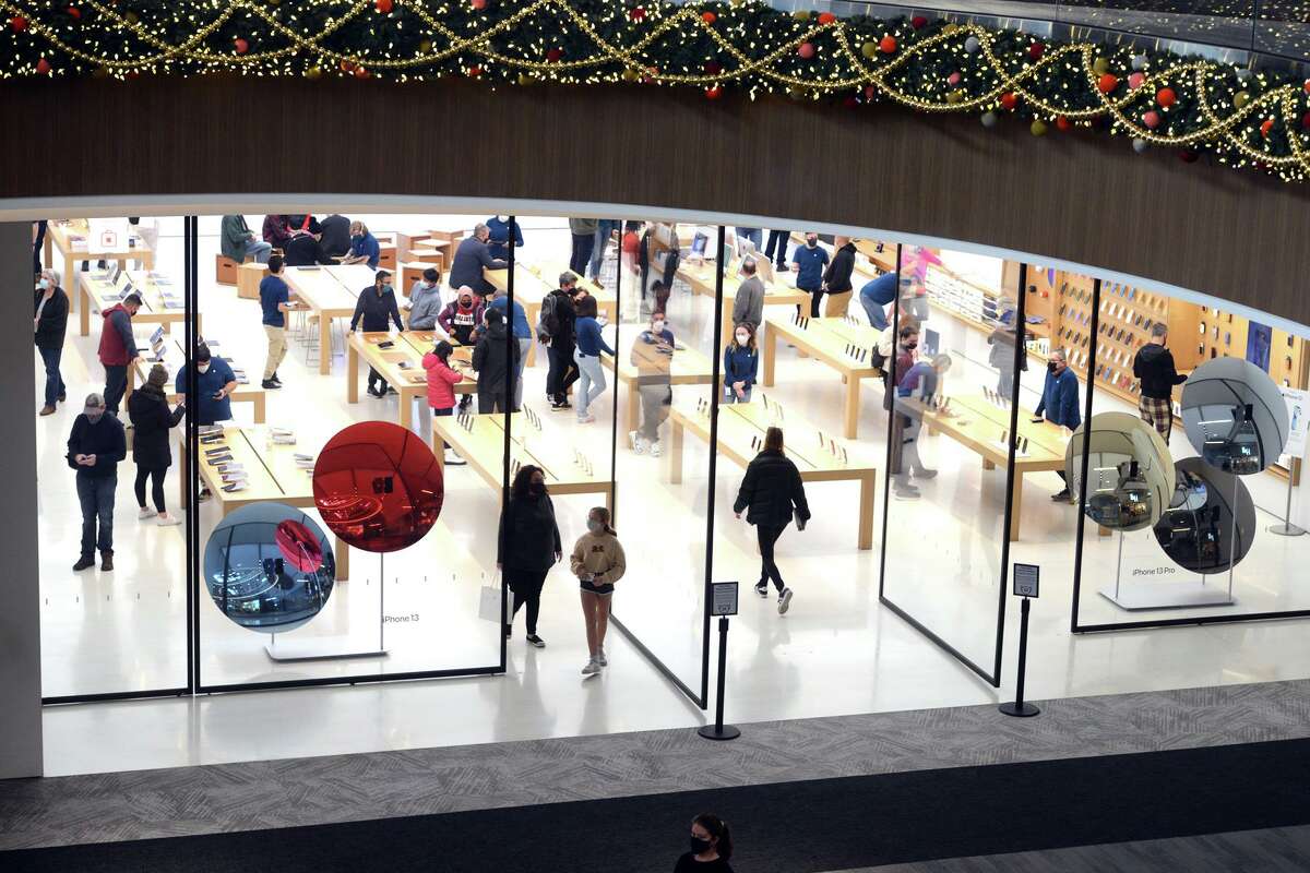 Shoppers peruse the Apple store on Black Friday at The SoNo Collection in Norwalk, Conn., on Nov. 26, 2021.