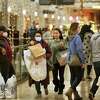 Black Friday shoppers take advantage of steep sale prices at many stores at the Connecticut Post Mall in Milford, Conn., on Nov. 26, 2021.