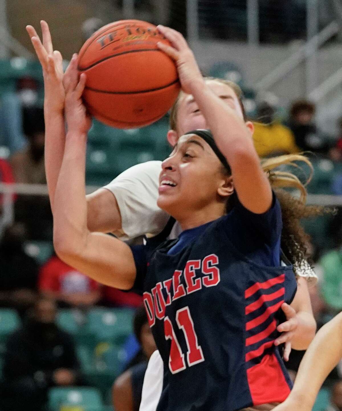 Dulles Nya Threatt (11) looks to shoot around Tompkins Macy Spencer (32) during girls basketball playoff game at the Merrell Center Wednesday, Feb. 24, 2021 in Katy.