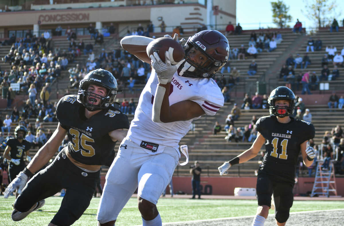 Abernathy's Anthony White hauls in the touchdown reception in front of Canadian defenders Luke Flowers (35) and Preston Miller during their Class 3A Division II region semifinal football game on Friday afternoon in Dick Bivins Stadium at Amarillo. 