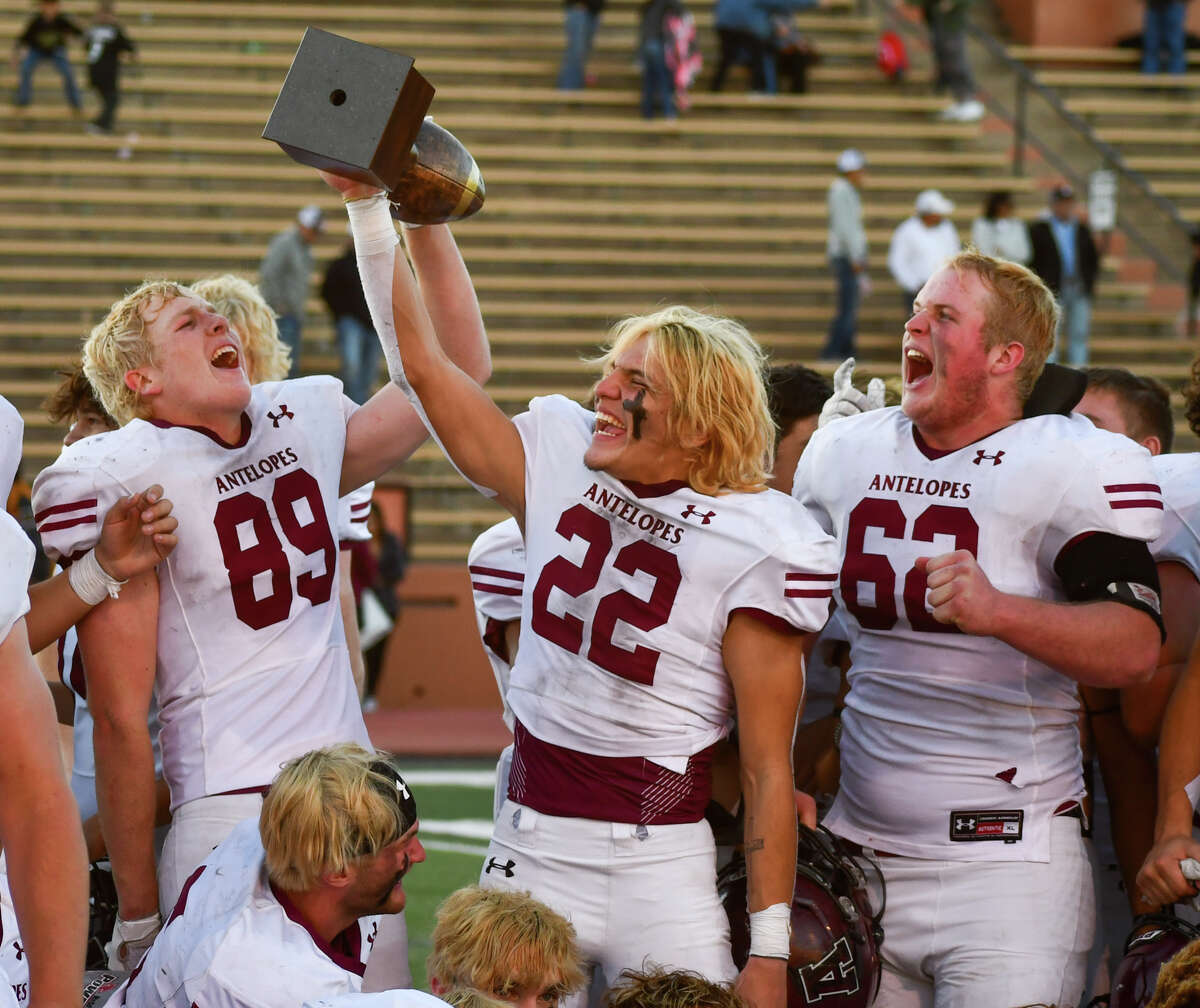 Abernathy players, from left, Landry Miller, Sean Rodriguez and Cole Vandygriff celebrate with the gold ball trophy. 