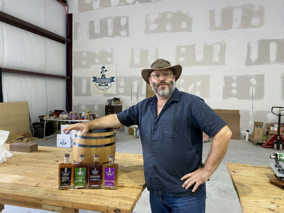 Joe Breda, owner and chief distiller of the Old Humble Distilling Company, displays his company’s four lines of spirits.