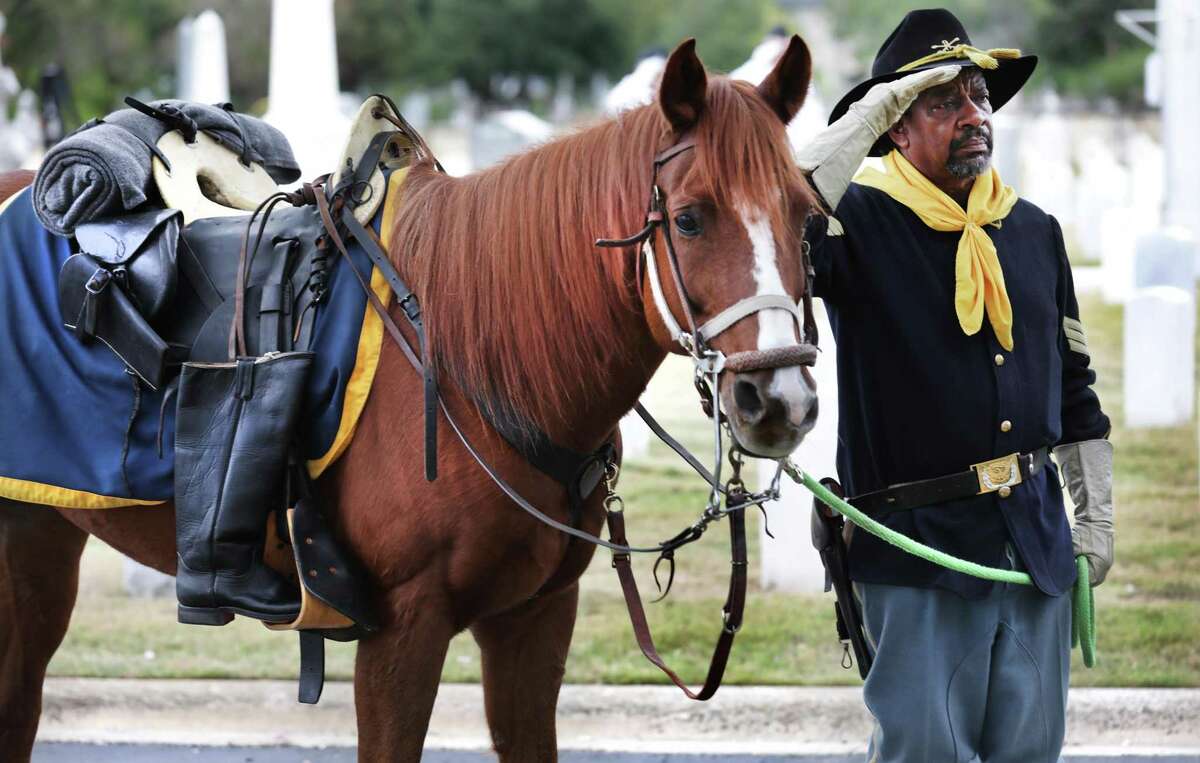 Bobby Ray Carter of the Bexar County Buffalo Soldiers leads a horse honoring the Missing Soldier during Veterans Day Commemorative Ceremony featuring The Bexar County Buffalo Soldiers at San Antonio National Cemetery in 2019. A Buffalo Soldiers monument is planned for Pletz County Park on the East Side, under a change in location requested by Native American activists.