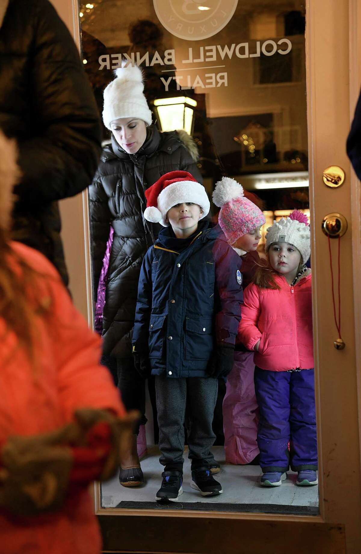 Children line up outside the Coldwell Banker office on Main Street, waiting for their turn to talk with Santa and Mrs. Claus. Ridgefield welcomed the holiday season on Nov. 26 with 17,000 lights, songs and a visit from Santa and Mrs. Claus.