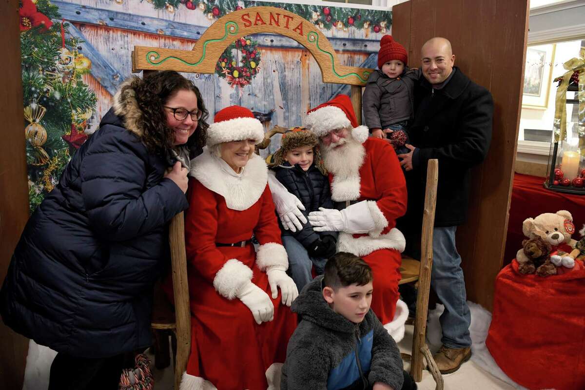 The Pink family, of Brookfield, visit with Santa and Mrs. Claus during Ridgefield’s annual tree lighting on Nov. 26.