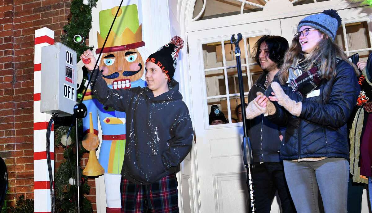 Logan Hale, right, flips the switch to illuminate the holiday lights in downtown. Ridgefield welcomed the holiday season on Nov. 26 with 17,000 lights, songs and a visit from Santa and Mrs. Claus.
