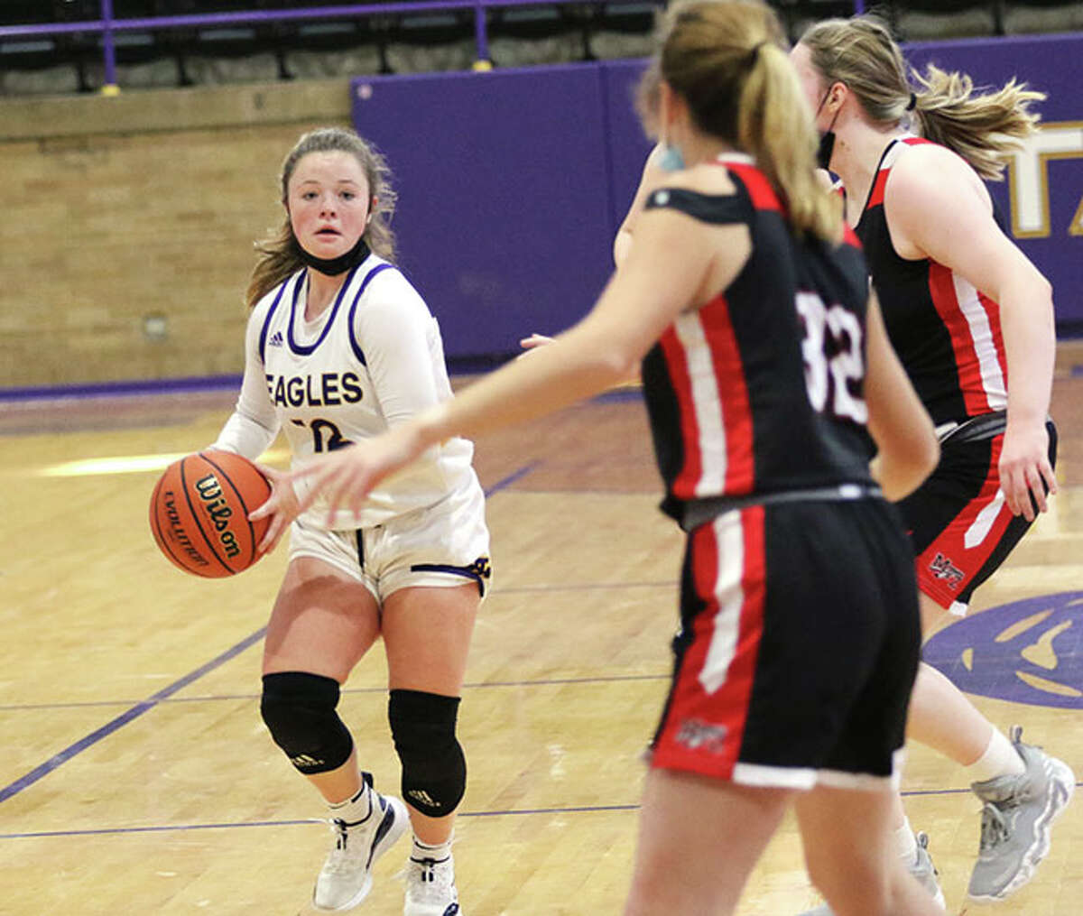 CM's Aubree Wallace (left), shown delivering a pass in a game last Saturday against Mount Zion at the Taylorville Tourney, had eight rebounds and eight assists Friday night in the Eagles' tourney win over Hillsboro.