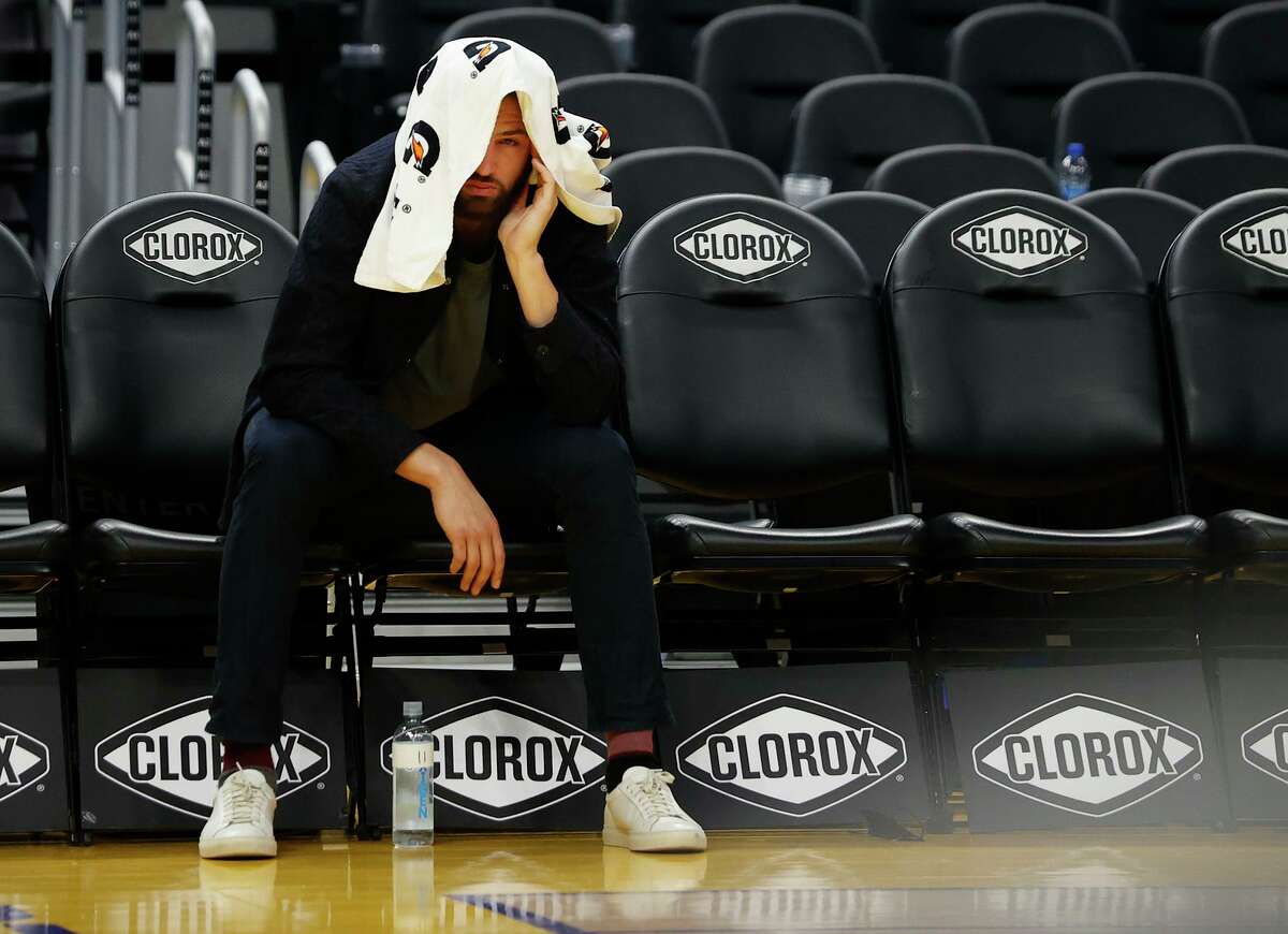 Warriors guard Klay Thompson sits alone on the bench after his team defeated the Trail Blazers on Friday night.