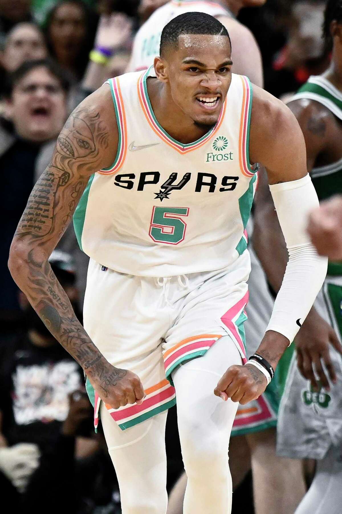 San Antonio Spurs' Dejounte Murray celebrates a basket late in the fourth quarter of an NBA basketball game against the Boston Celtics, Friday, Nov. 26, 2021, in San Antonio. (AP Photo/Darren Abate)