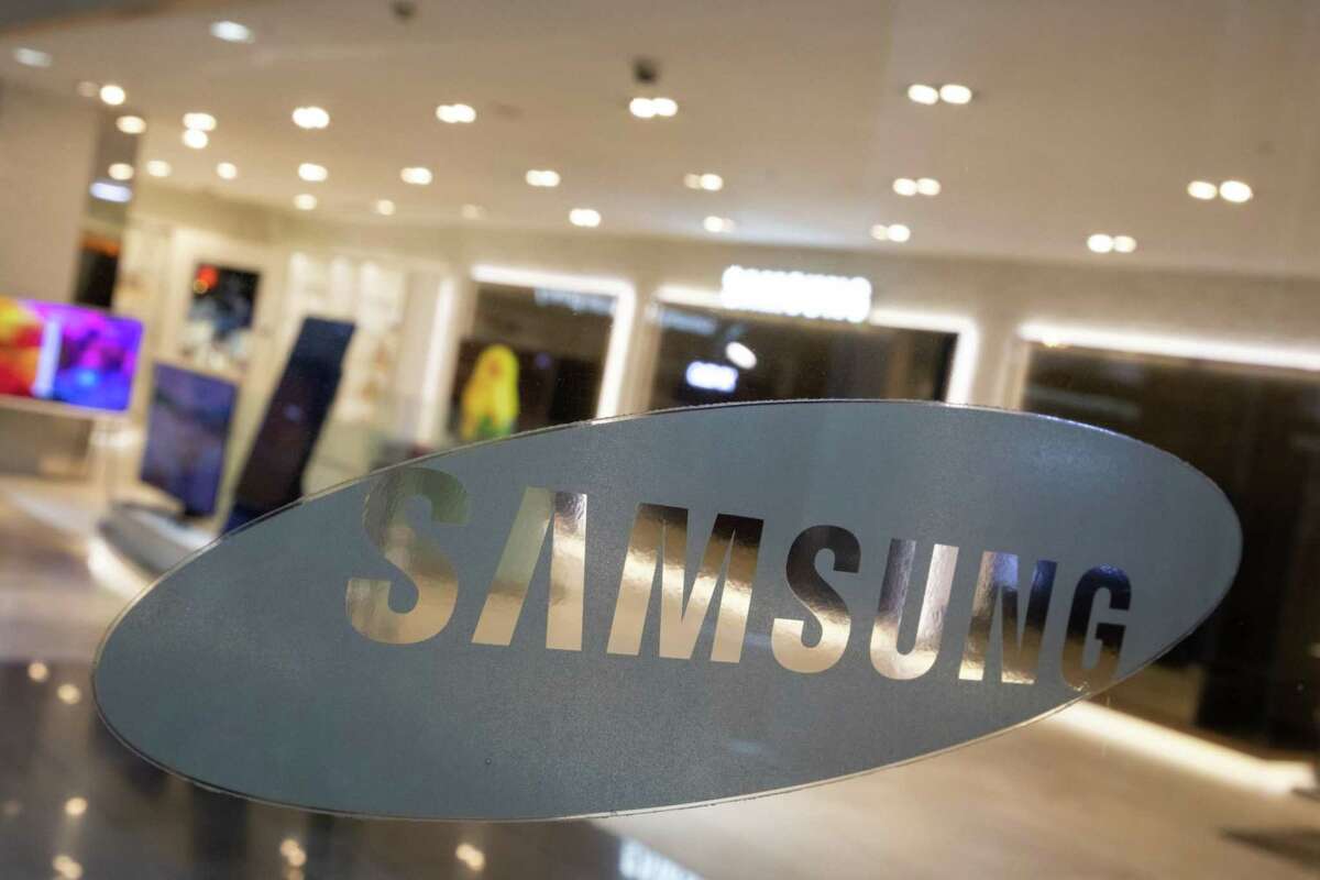 The Samsung Electronics logo is displayed in a window at the company's D'light flagship store in Seoul, South Korea, on Oct. 6, 2020. MUST CREDIT: Bloomberg photo by SeongJoon Cho.