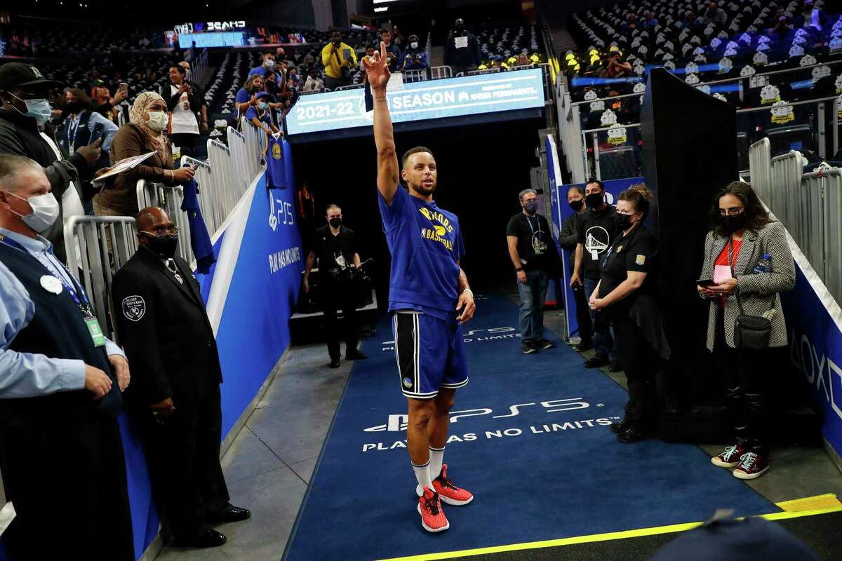 Golden State Warriors' Stephen Curry prepares for a full court shot after warming up before playing Los Angeles Clippers in NBA game at Chase Center in San Francisco, Calif., on Thursday, October 21, 2021.