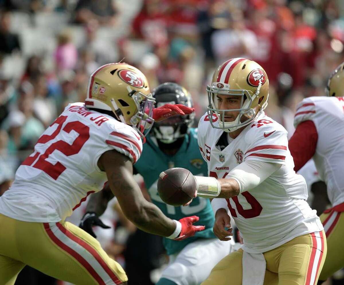 Jimmy Garoppolo hands off to running back Jeff Wilson Jr. against the Jaguars, when the 49ers rushed for 171 yards.