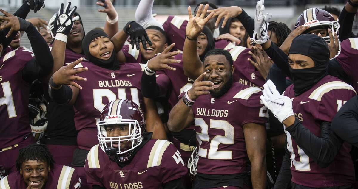 Summer Creek Bulldogs players celebrate the Bulldogs' 62-41 win over Cinco Ranch in a Class 6A Division I regional semifinal high school football game Saturday, Nov. 27, 2021 in Houston.
