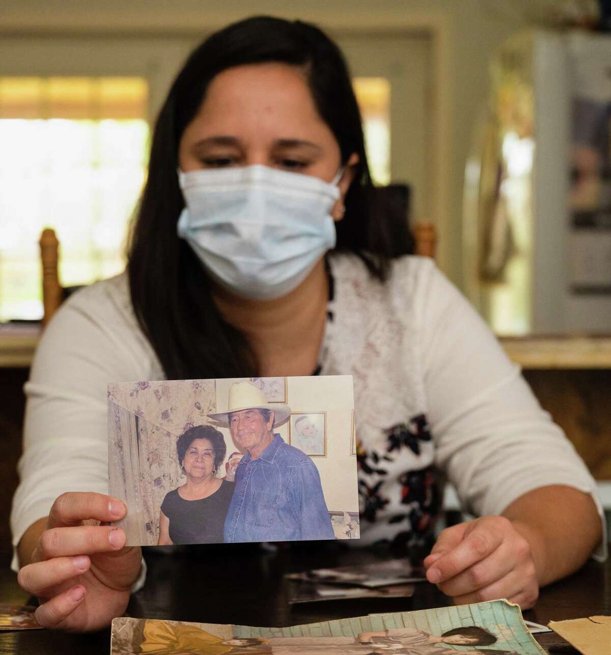 Erika Gonzalez holds a picture of her parents, Augustina and Juan Gonzalez. Both suffered from Alzheimer’s, a devastating disease which can lead to significant memory problems.