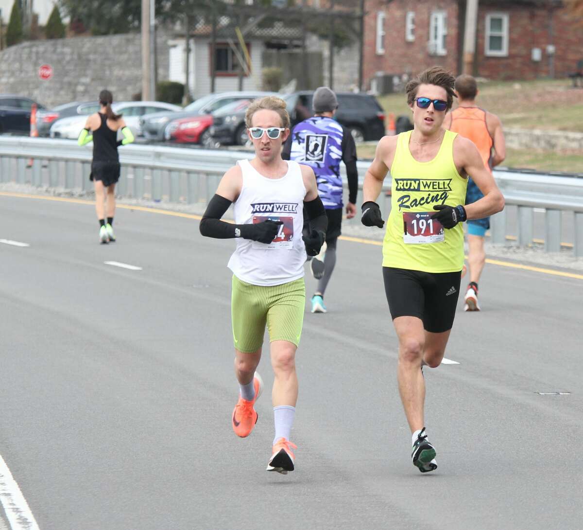 Jake Peal (134) and Luke Padesky (191) lead the pack on the return trip during the annual Great River Road Run Saturday. Padesky scored the best time at 54:55.9, with Peal coming in at 55:15.2. Sponsored by the Alton Road Runner's Club, it attracted about 330 participants this year.